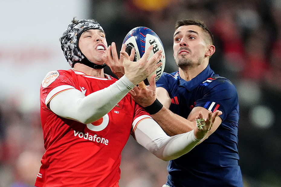 Wales' Tom Rogers and France's Thomas Ramos battle for the ball during the Guinness Men's Six Nations match at the Stade de France in Paris, France.